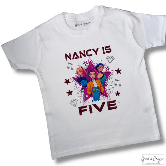 "Close-up of personalised K-Pop Huntrix birthday t-shirt showing vibrant graffiti lettering with custom name and age detail"