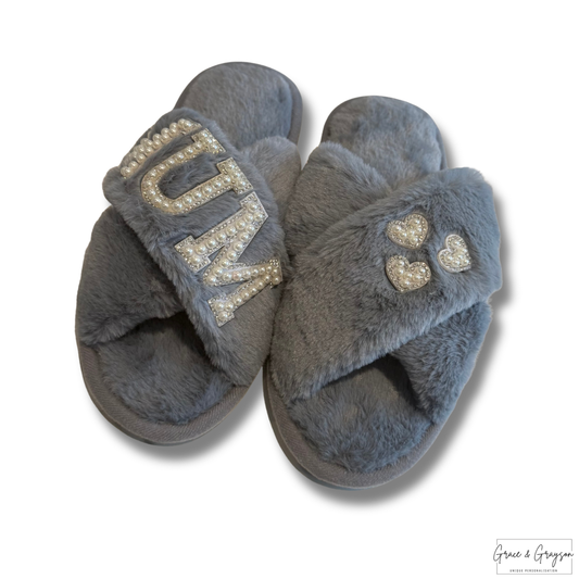 "Close up of luxury faux fur slippers with pearl Mum lettering detail"