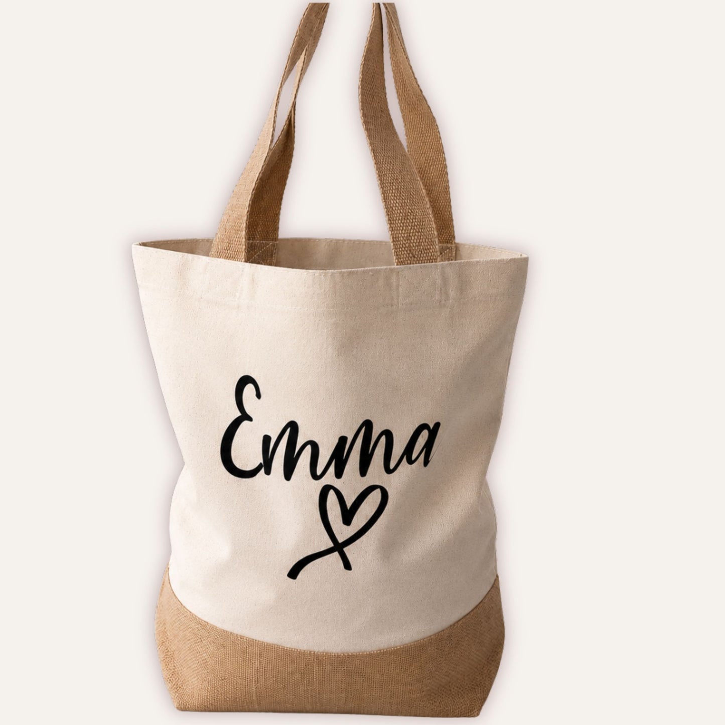 Personalised heart jute tote bag with custom name in script font and heart motif below, cream canvas with natural jute base panel | Grace & Grayson