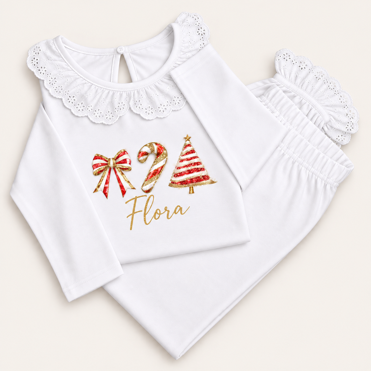 Personalised white Christmas frill pyjamas with red bow, Christmas tree and candy cane design by Grace & Grayson