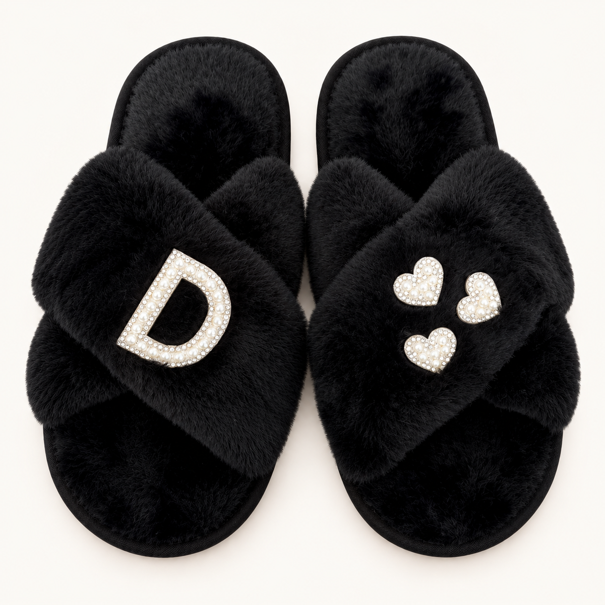 Black faux fur crossover slippers with a pearl initial and three pearl hearts with silver-tone edging, Grace & Grayson.