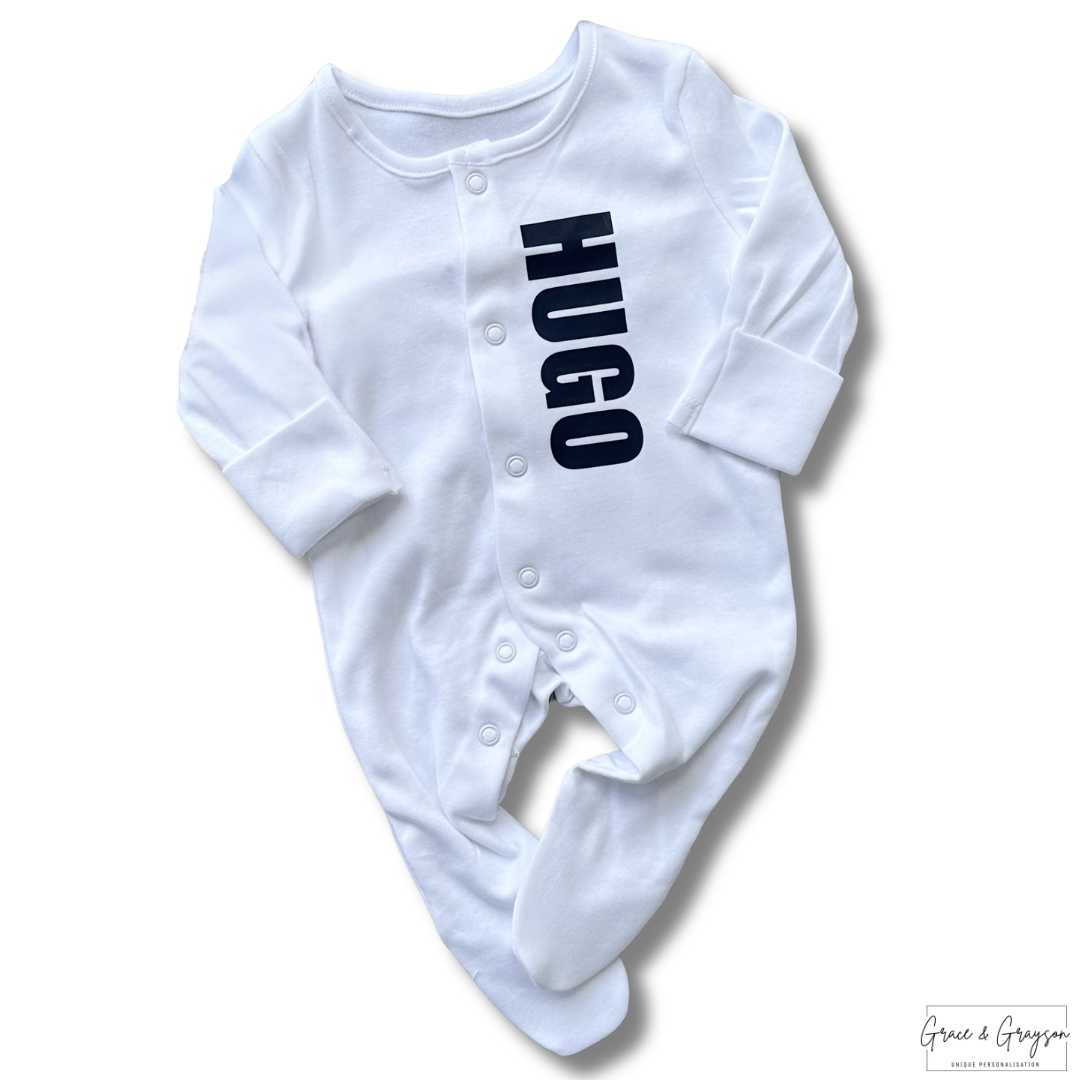 Personalised block name baby grow set with custom name in colourful block letters on white babygrow