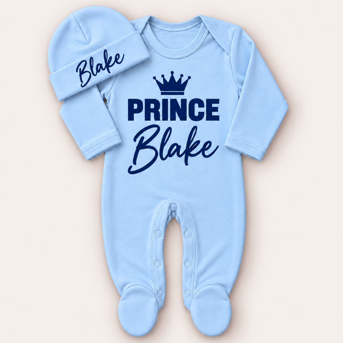Blue personalised Prince baby grow and matching hat with navy crown lettering, Grace & Grayson