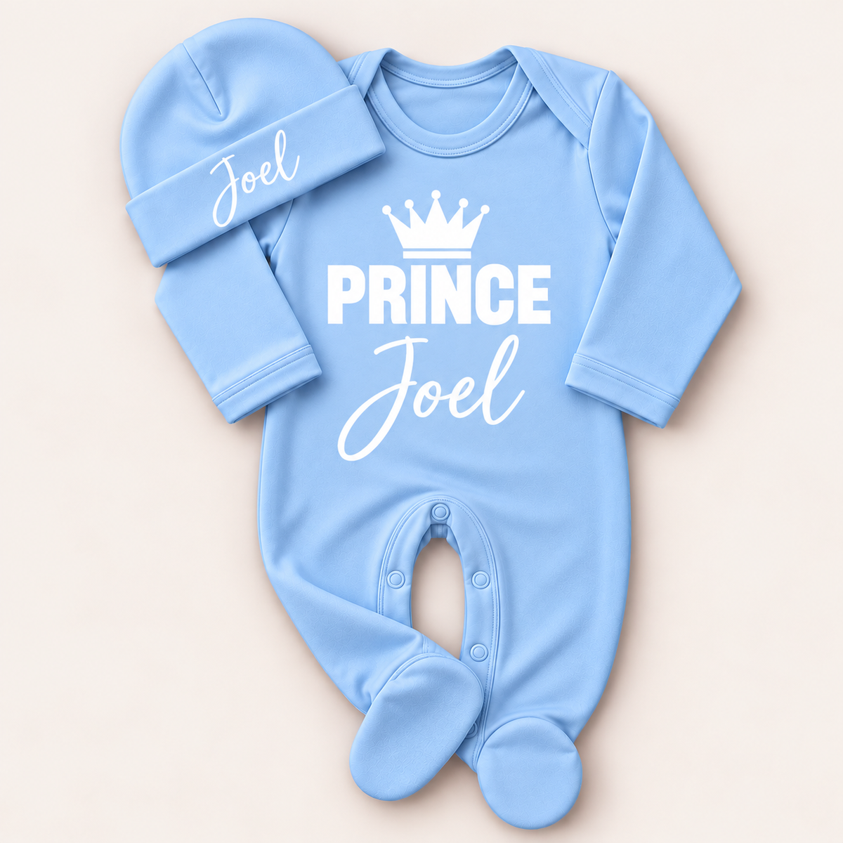 Blue personalised Prince baby grow and matching hat with white crown lettering, Grace & Grayson