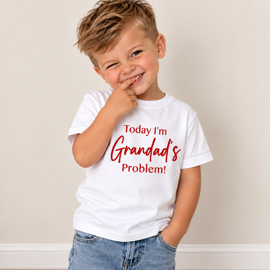 Child modelling a white personalised “Today I'm Grandad's Problem!” t-shirt, Grace & Grayson.
