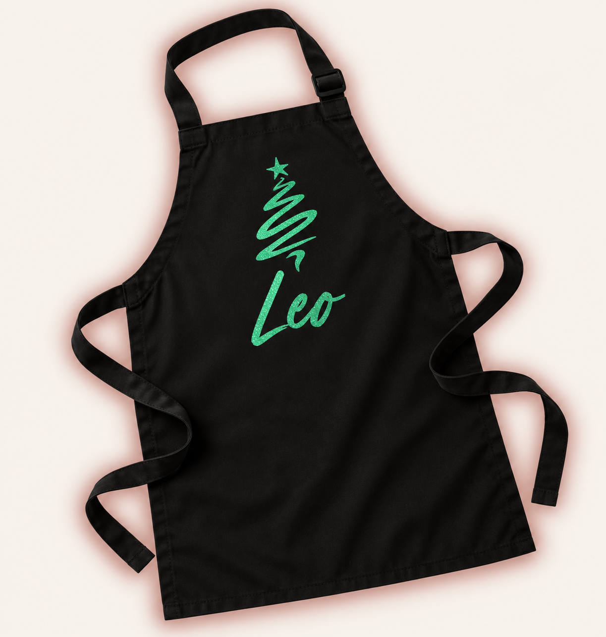 Close-up of a personalised children’s Christmas apron with a festive design, Grace & Grayson