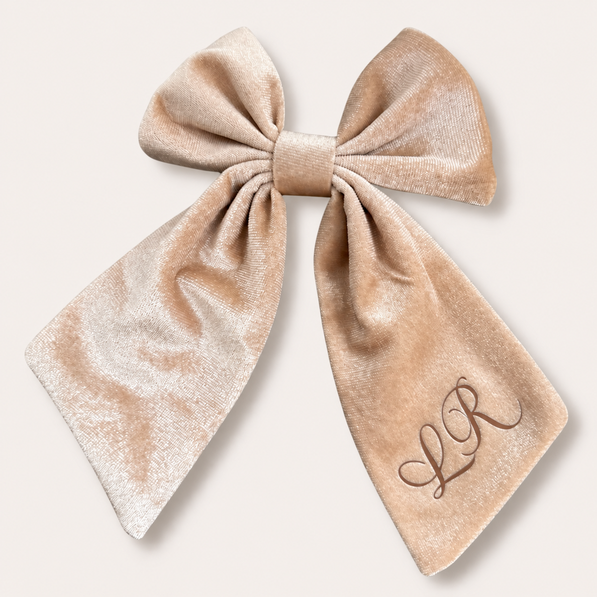 Cream personalised velvet hair bow with brown fancy initials, displayed flat, Grace & Grayson