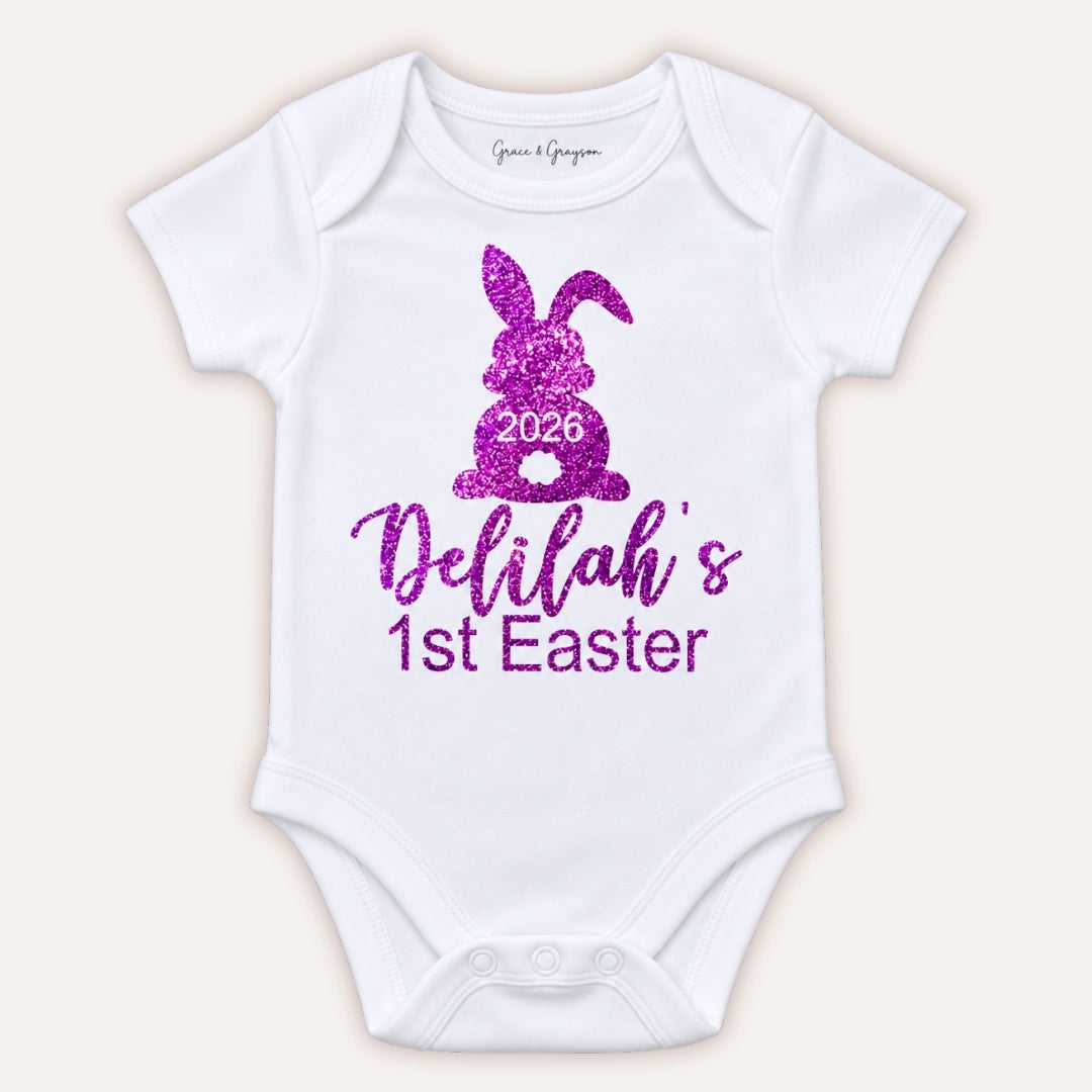 White personalised 1st Easter baby vest with a purple glitter bunny design and 2026 detail, Grace & Grayson