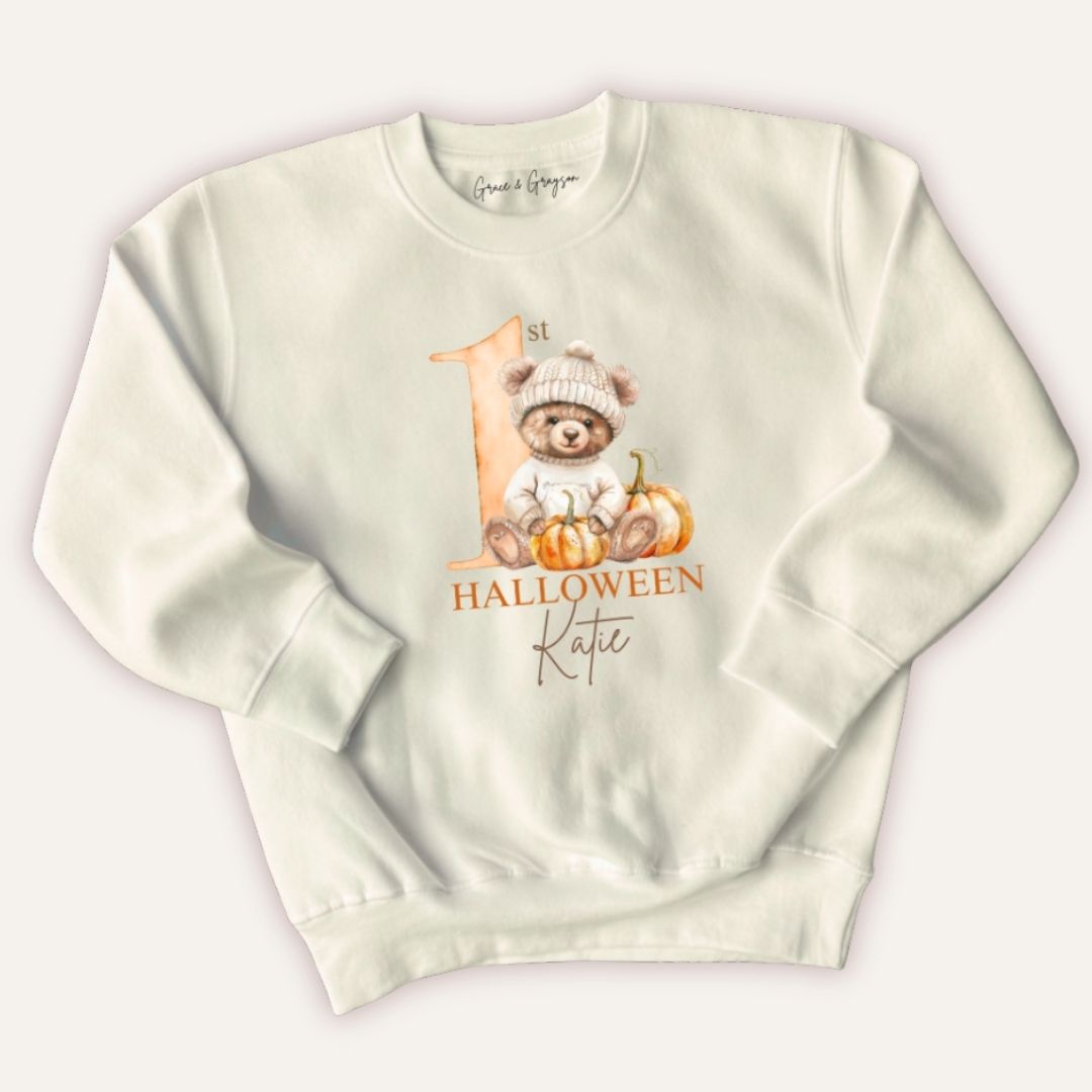 Flat lay of Grace & Grayson personalised 1st Halloween pumpkin bear sweatshirt with custom name print
