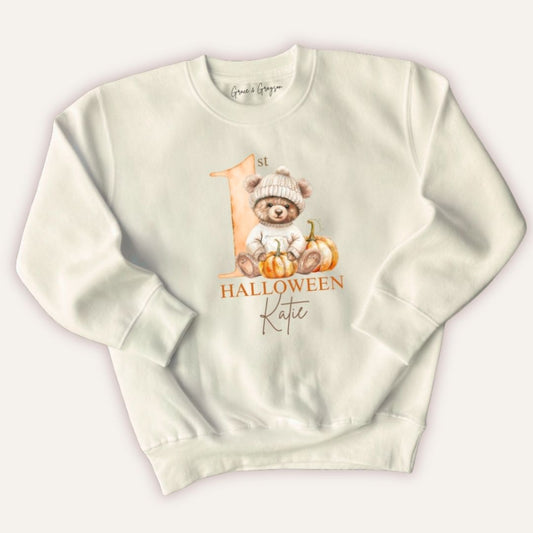 Flat lay of Grace & Grayson personalised 1st Halloween pumpkin bear sweatshirt with custom name print
