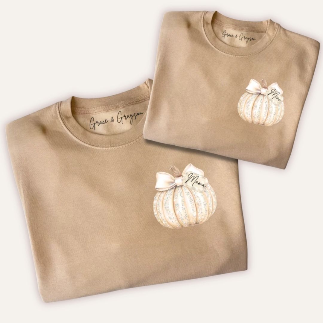 Folded personalised mama and mini sparkle pumpkin sweatshirts in warm taupe showing mama and mini name tag bow design by Grace & Grayson
