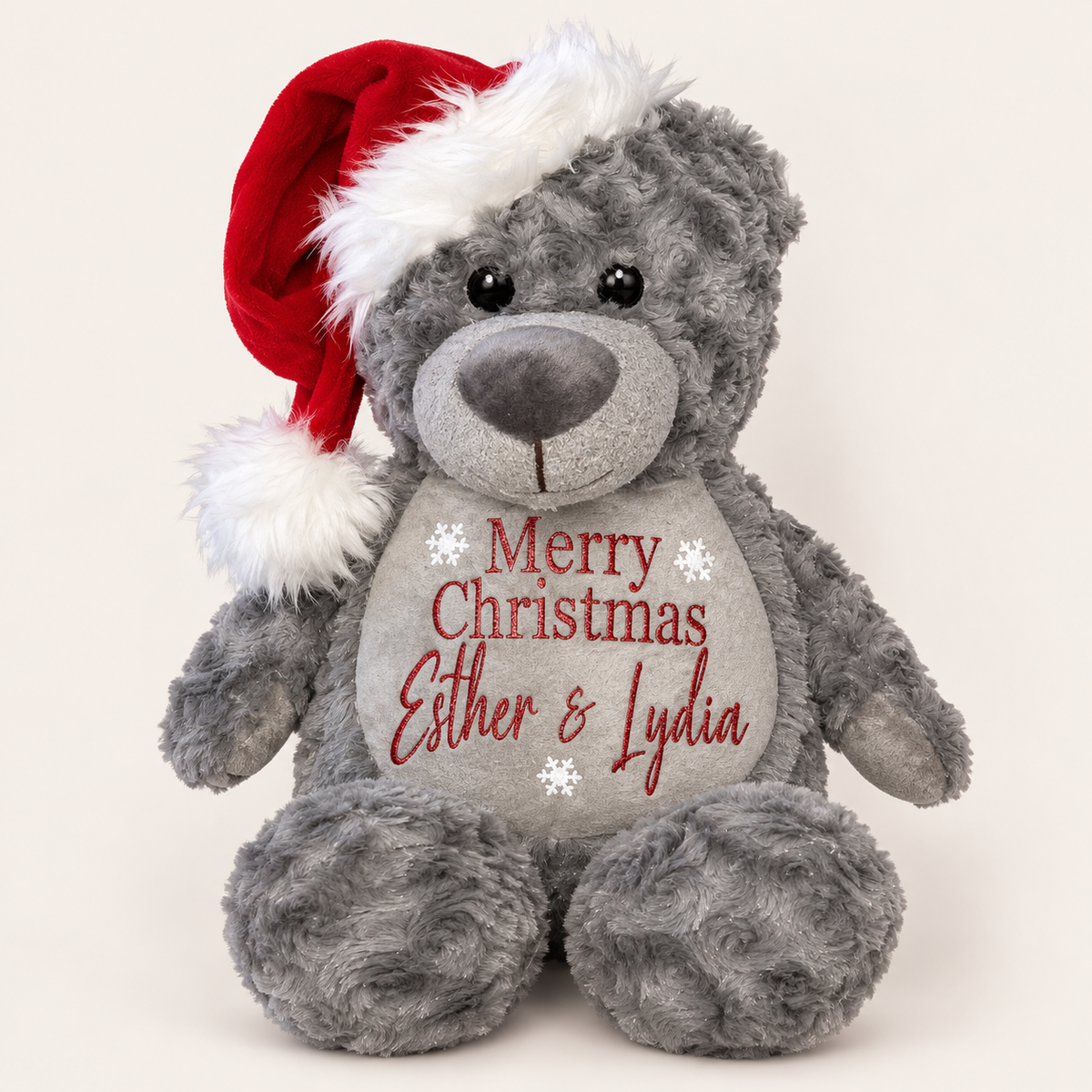Grey personalised Christmas teddy bear wearing a Santa hat with a family Merry Christmas design, displayed on a light background, Grace & Grayson