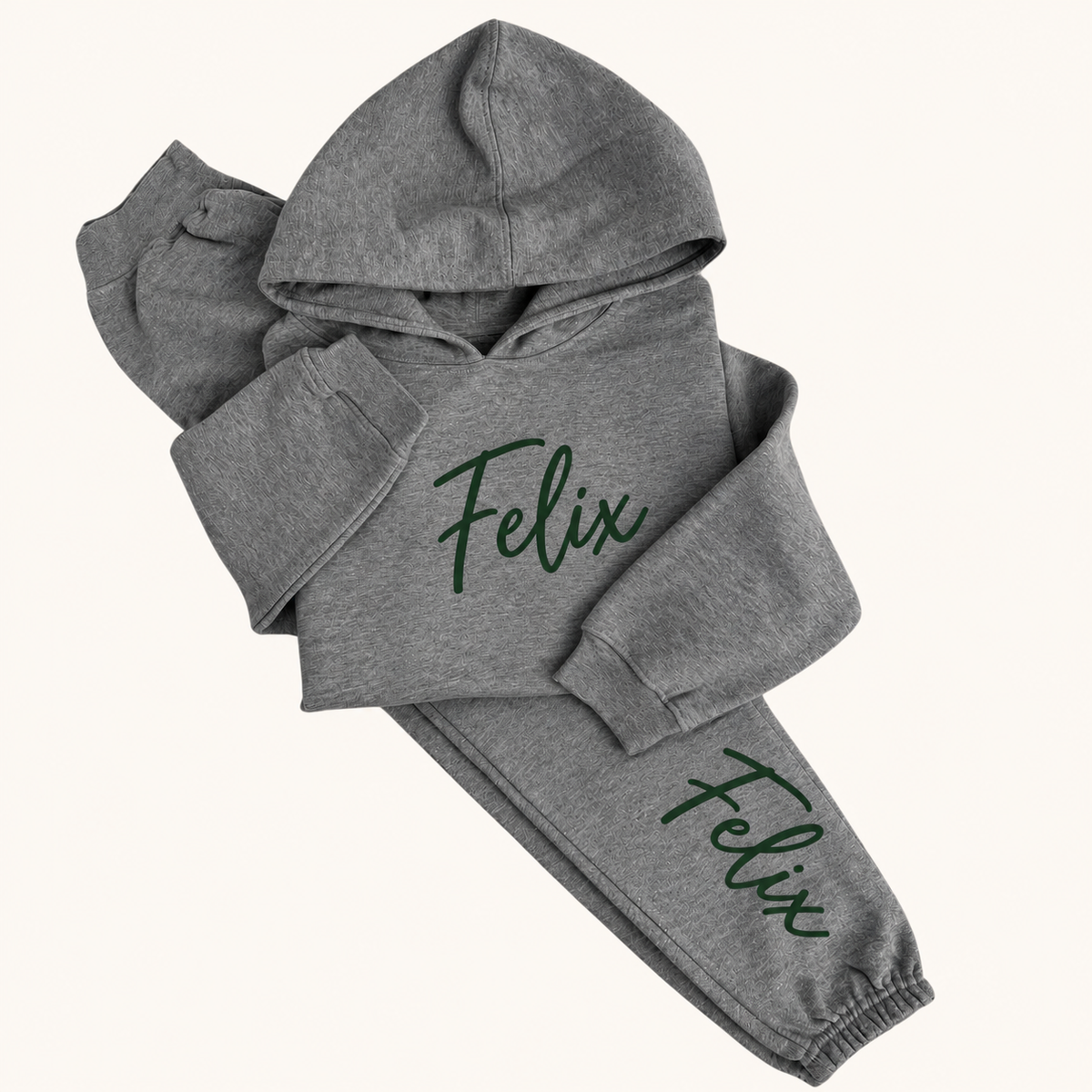 Grey marl personalised hoodie tracksuit with a dark green script name on the hoodie chest and jogger leg, Grace & Grayson
