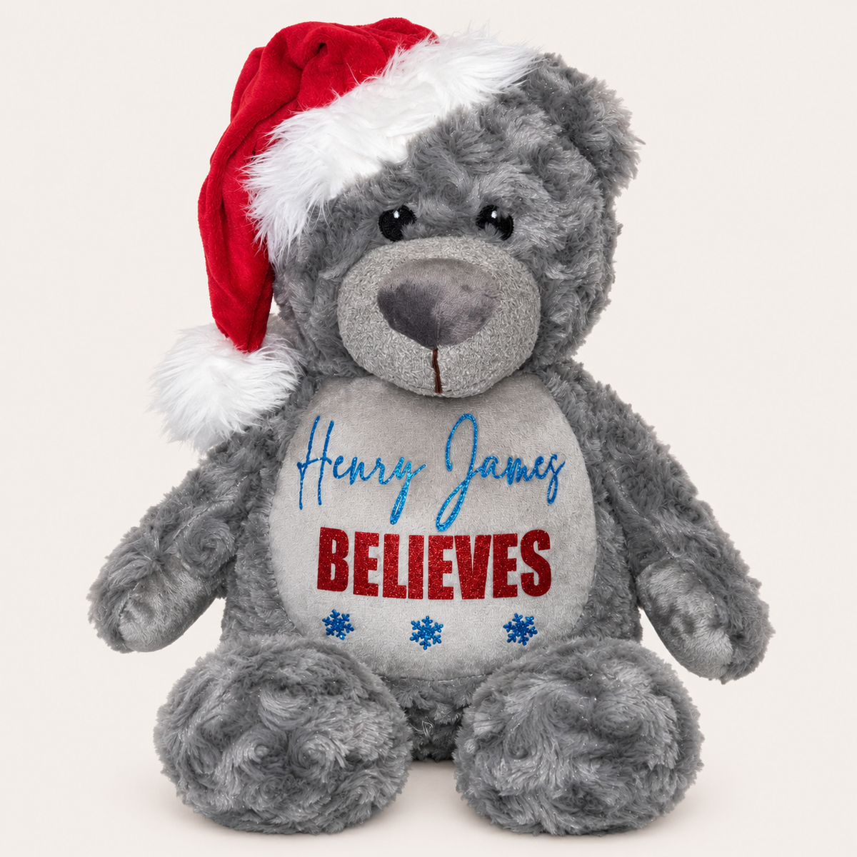 Grey personalised Believes Christmas teddy wearing a Santa hat with red and blue snowflake details, Grace & Grayson