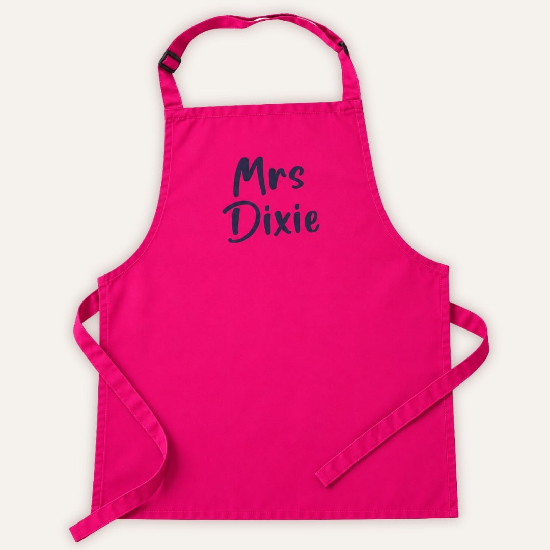 Hot pink personalised adult apron with dark custom lettering, displayed on a white background, Grace & Grayson