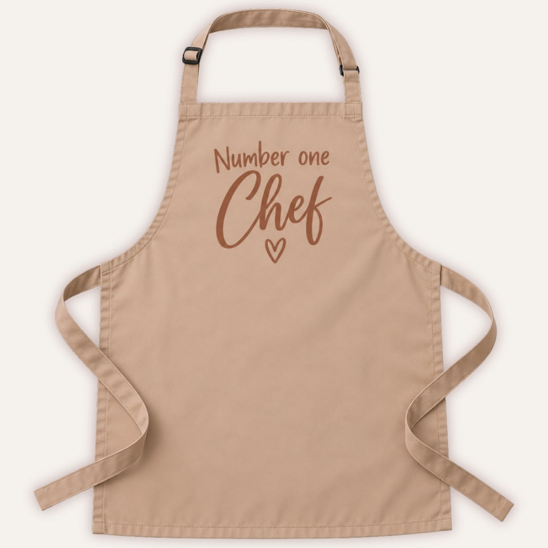 Latte colour personalised adult apron with “Number one Chef” text and heart design, displayed on a white background, Grace & Grayson