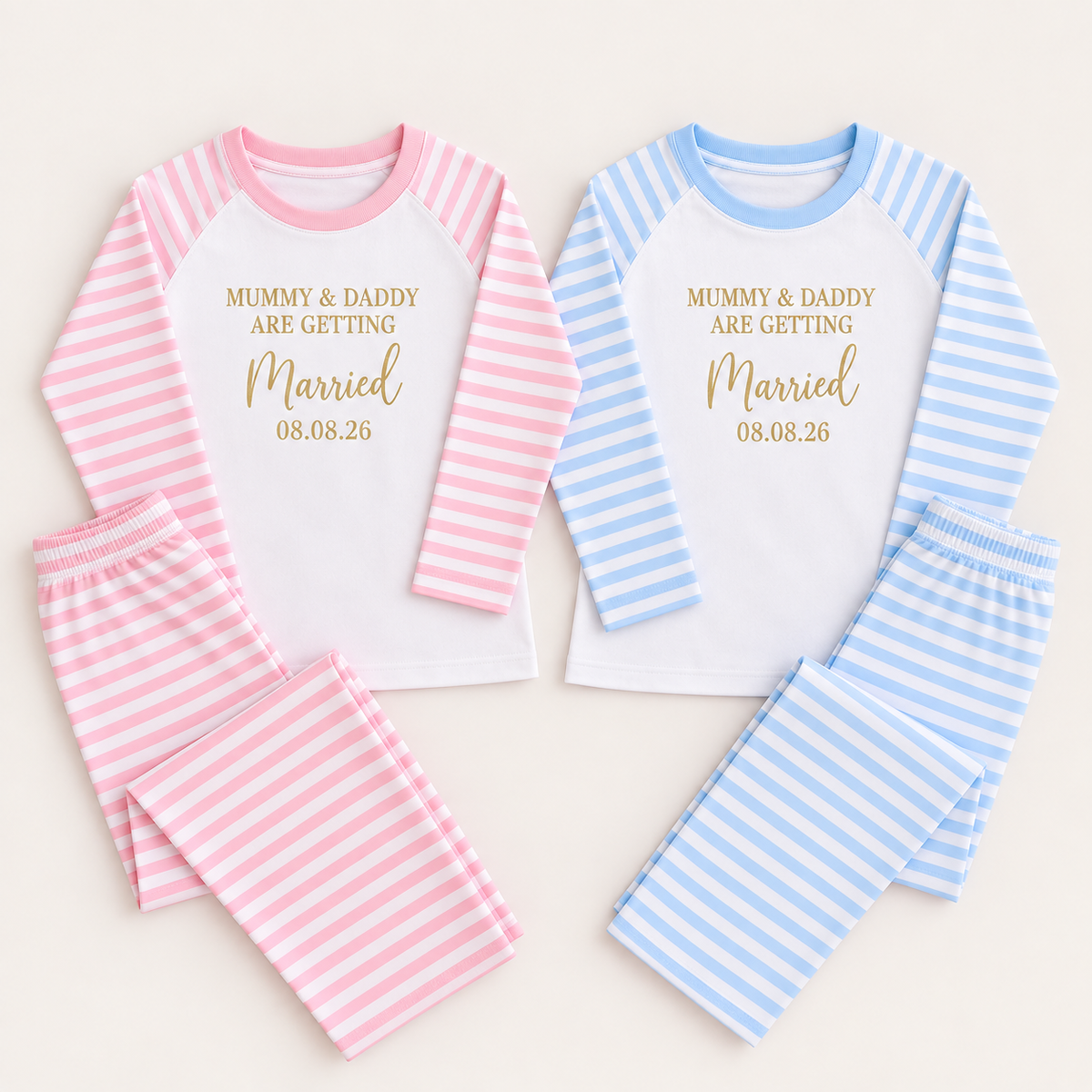 Matching pink and blue striped personalised children’s pyjamas laid flat with a “Mummy & Daddy Are Getting Married” design and date detail, Grace & Grayson