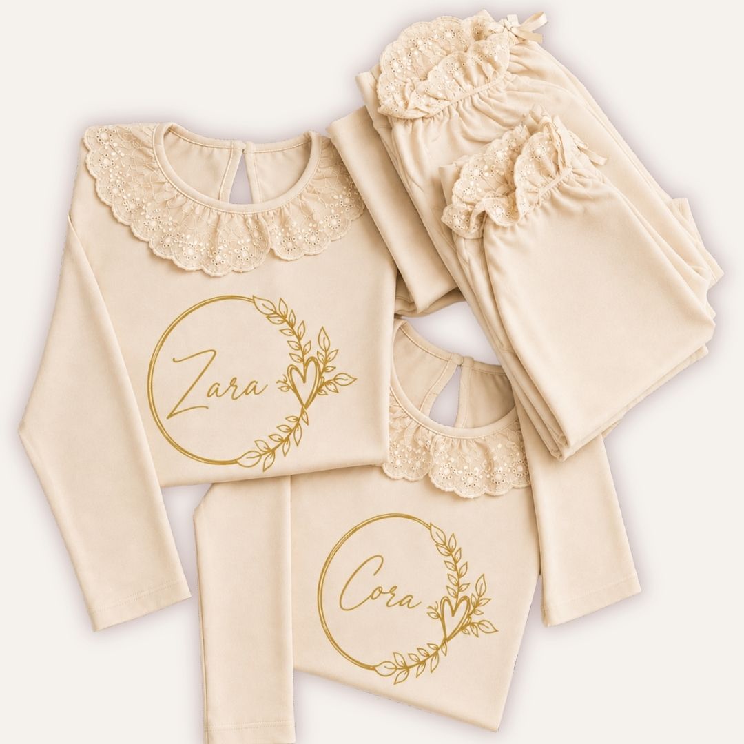 Natural personalised broderie frill pyjamas with gold wreath designs, displayed as a coordinated set, Grace & Grayson