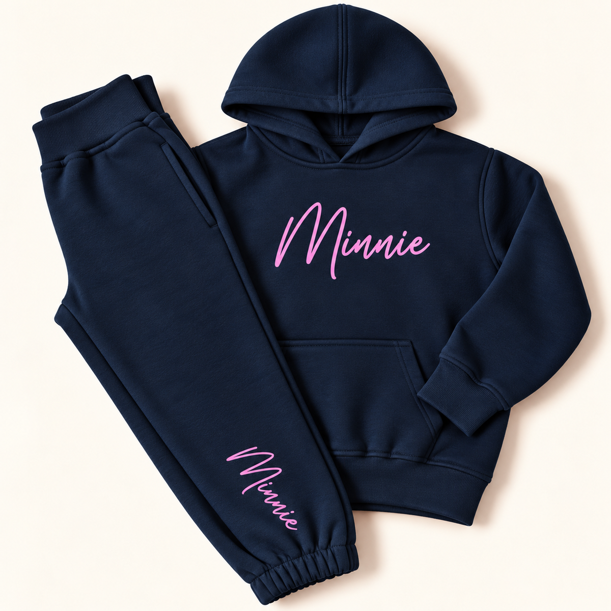 Navy personalised hoodie tracksuit with a pink script name on the hoodie chest and jogger leg, Grace & Grayson