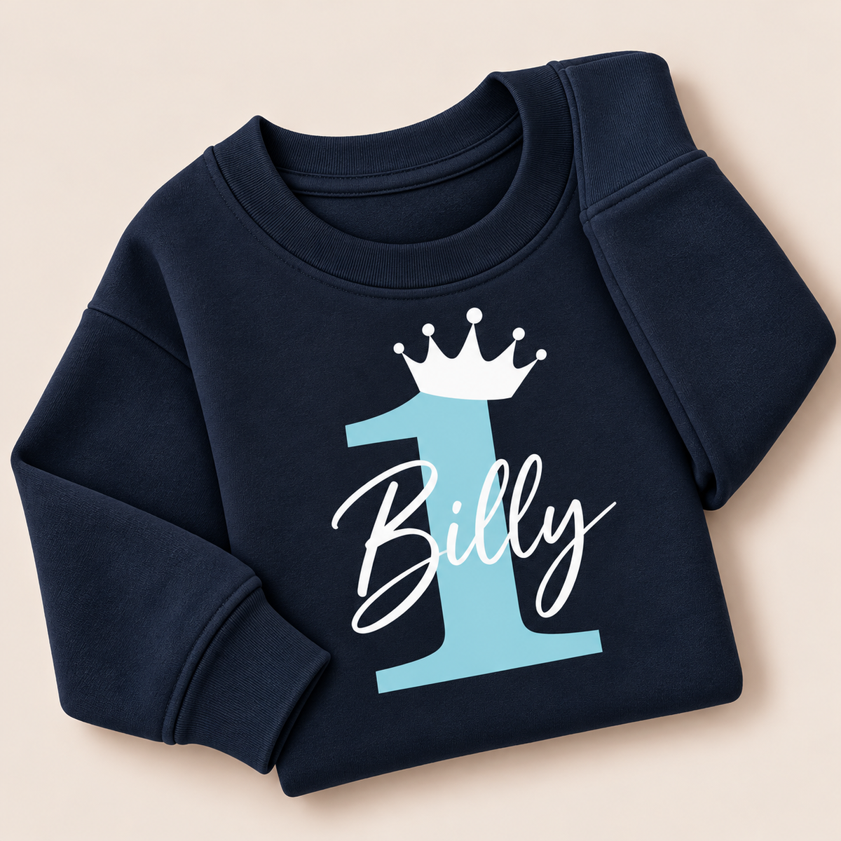 Navy personalised first birthday sweatshirt with a  baby blue number 1, white crown and white script name | Grace & Grayson