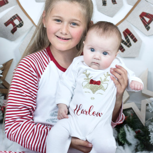 "Personalised Christmas reindeer baby grow with custom name in festive colours on white babygrow"