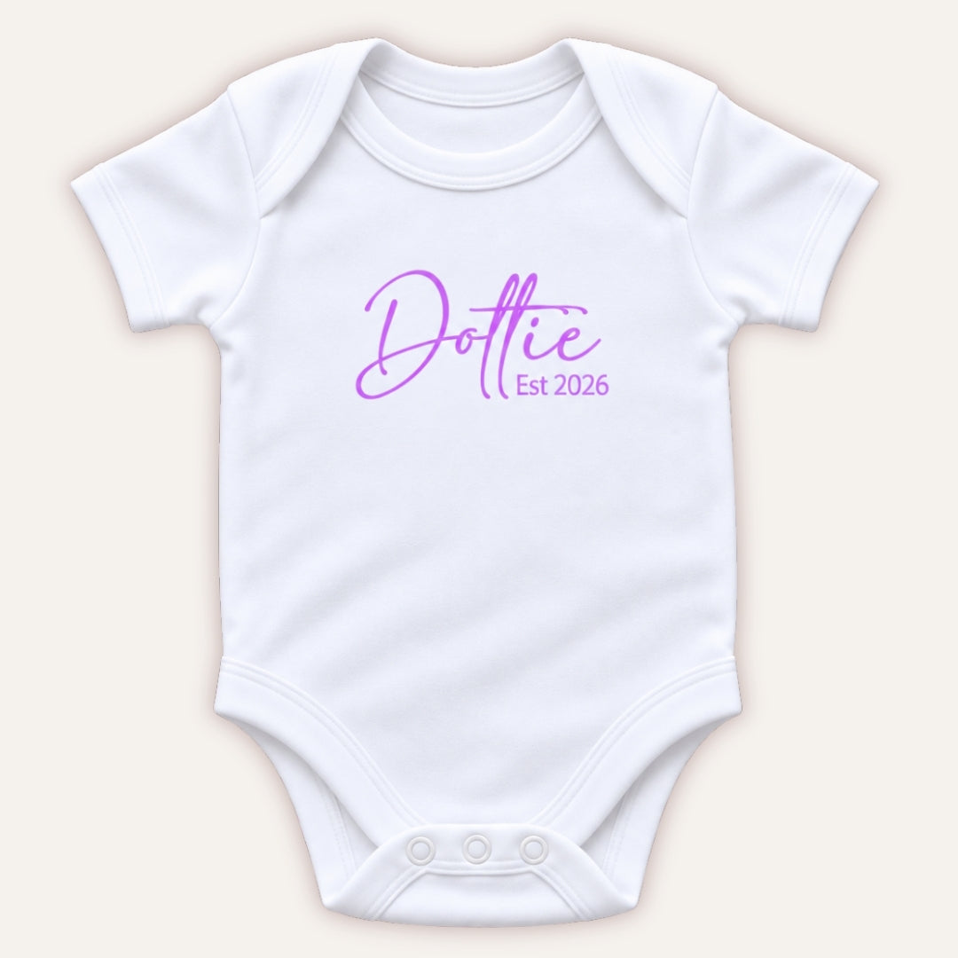Personalised EST baby vest in lilac featuring a baby’s name and year of birth, Grace & Grayson.