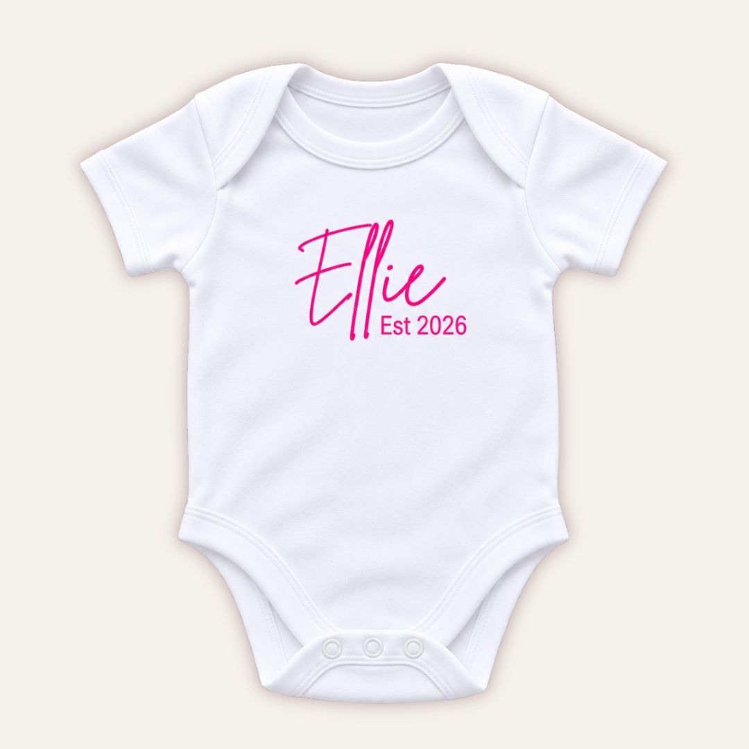 Personalised EST baby vest in pink featuring a baby’s name and year of birth, Grace & Grayson.