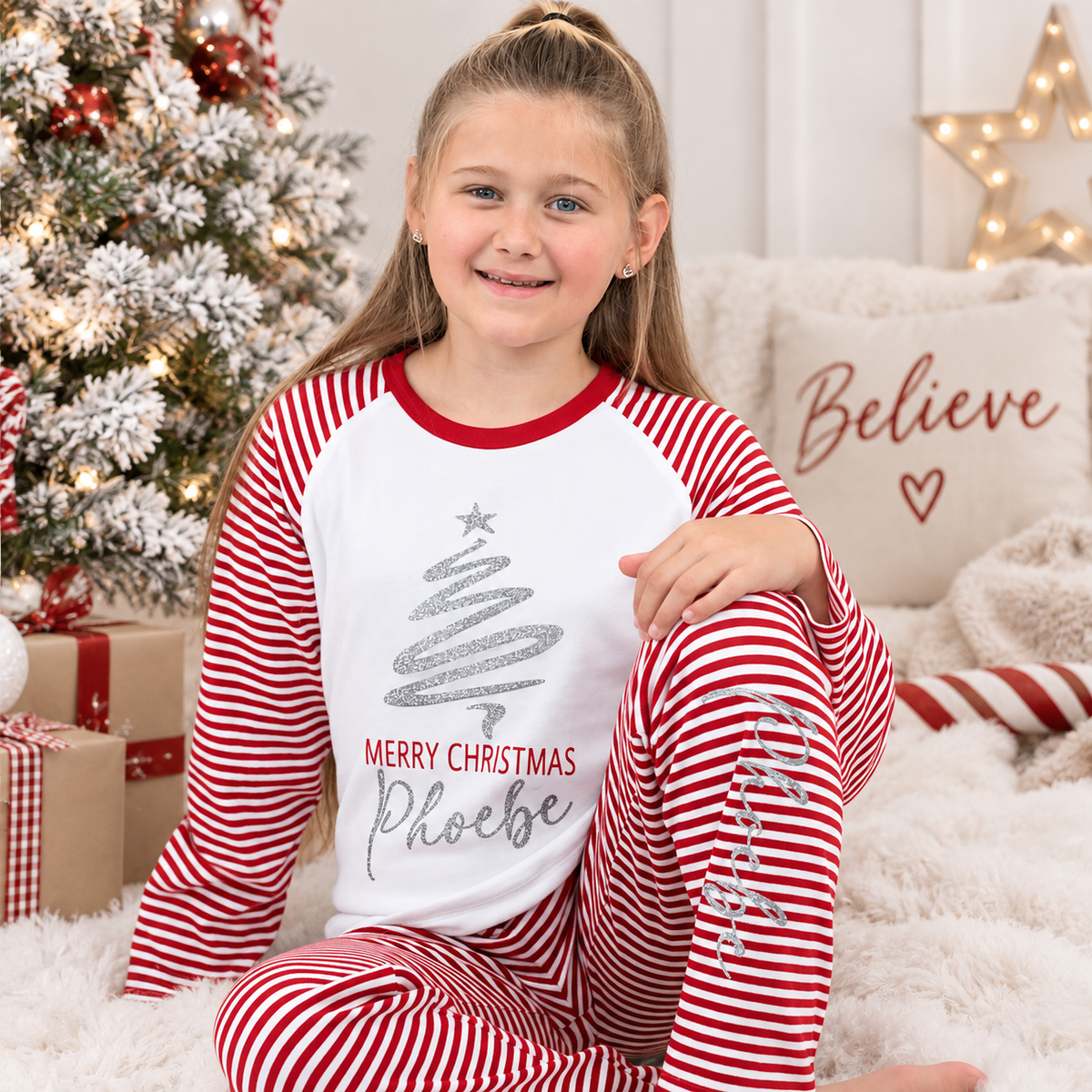 Personalised Merry Christmas red and white stripe children’s pyjamas with a reindeer design, Grace & Grayson