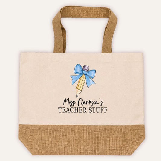 Personalised Teacher Stuff jute tote bag with bow and pencil design in light blue, custom teacher name in script font on cream canvas with jute base | Grace & Grayson