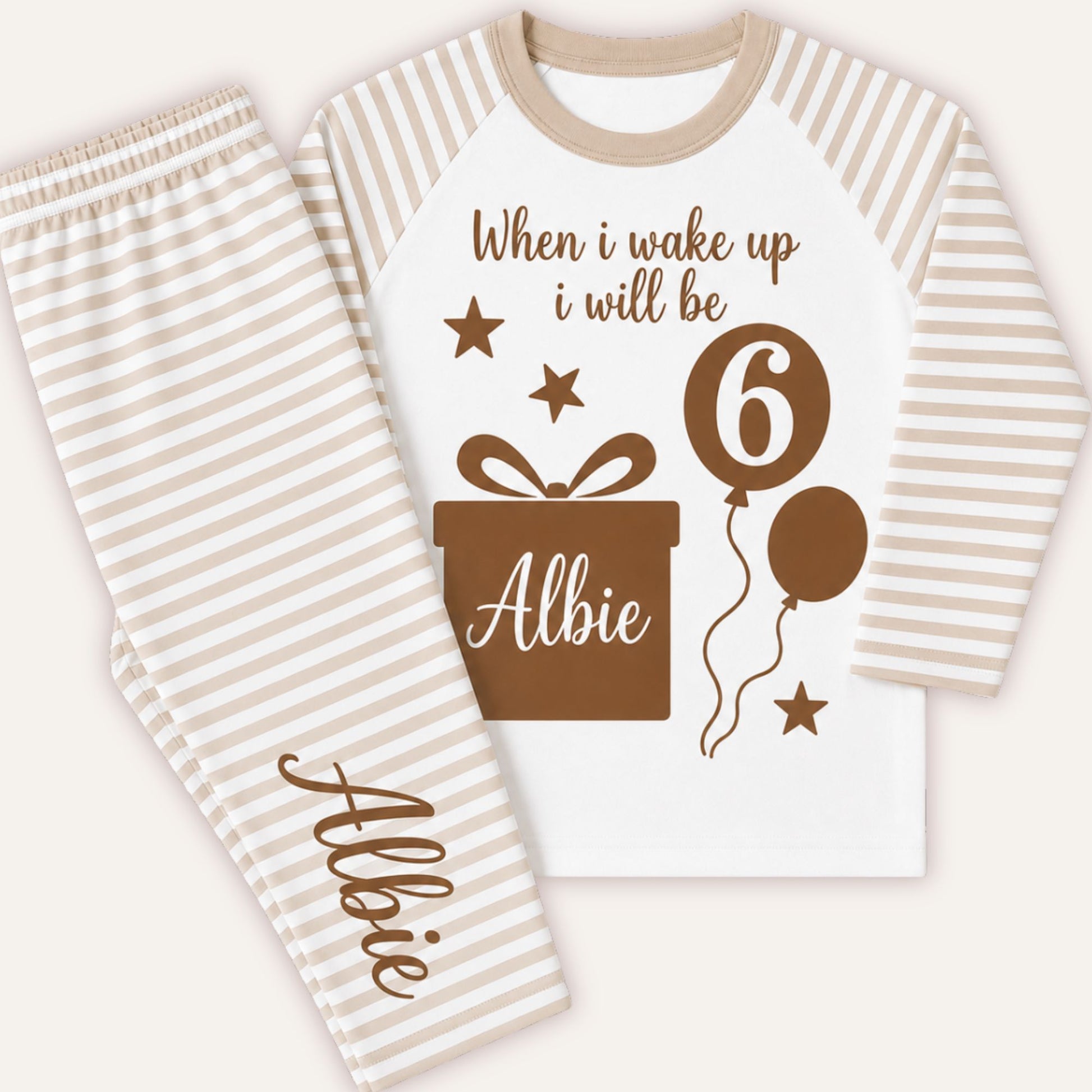 Personalised boys beige striped birthday pyjamas with tawny brown birthday gift design, custom name and age balloon.