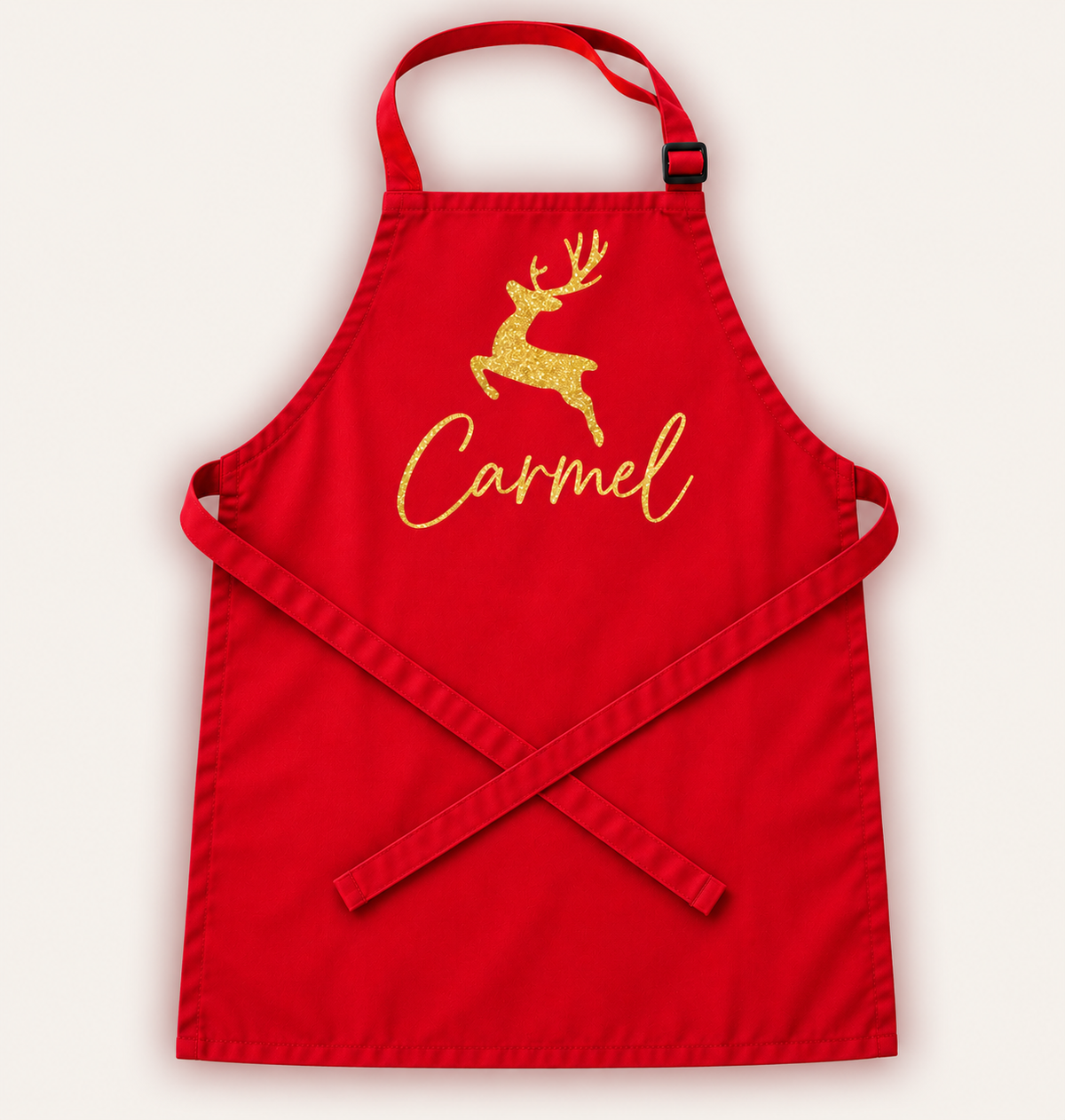 Personalised children’s Christmas apron shown from the front in a festive design, Grace & Grayson