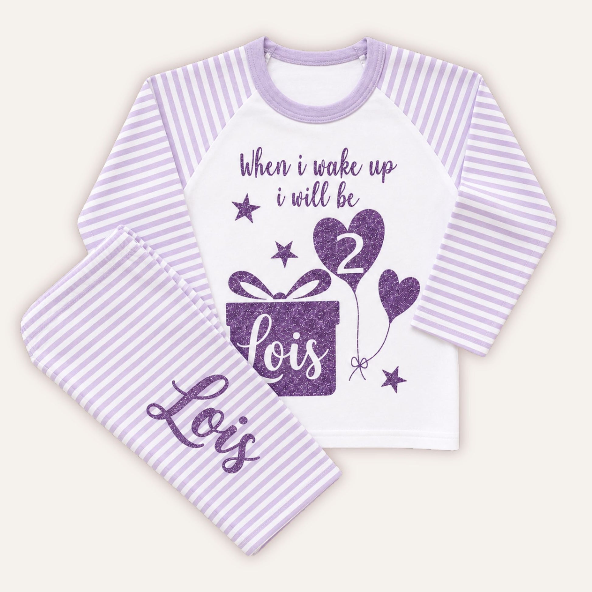 Personalised girls birthday pyjamas with lilac striped sleeves and trousers, purple glitter birthday design, age balloon and custom name on matching bottoms.