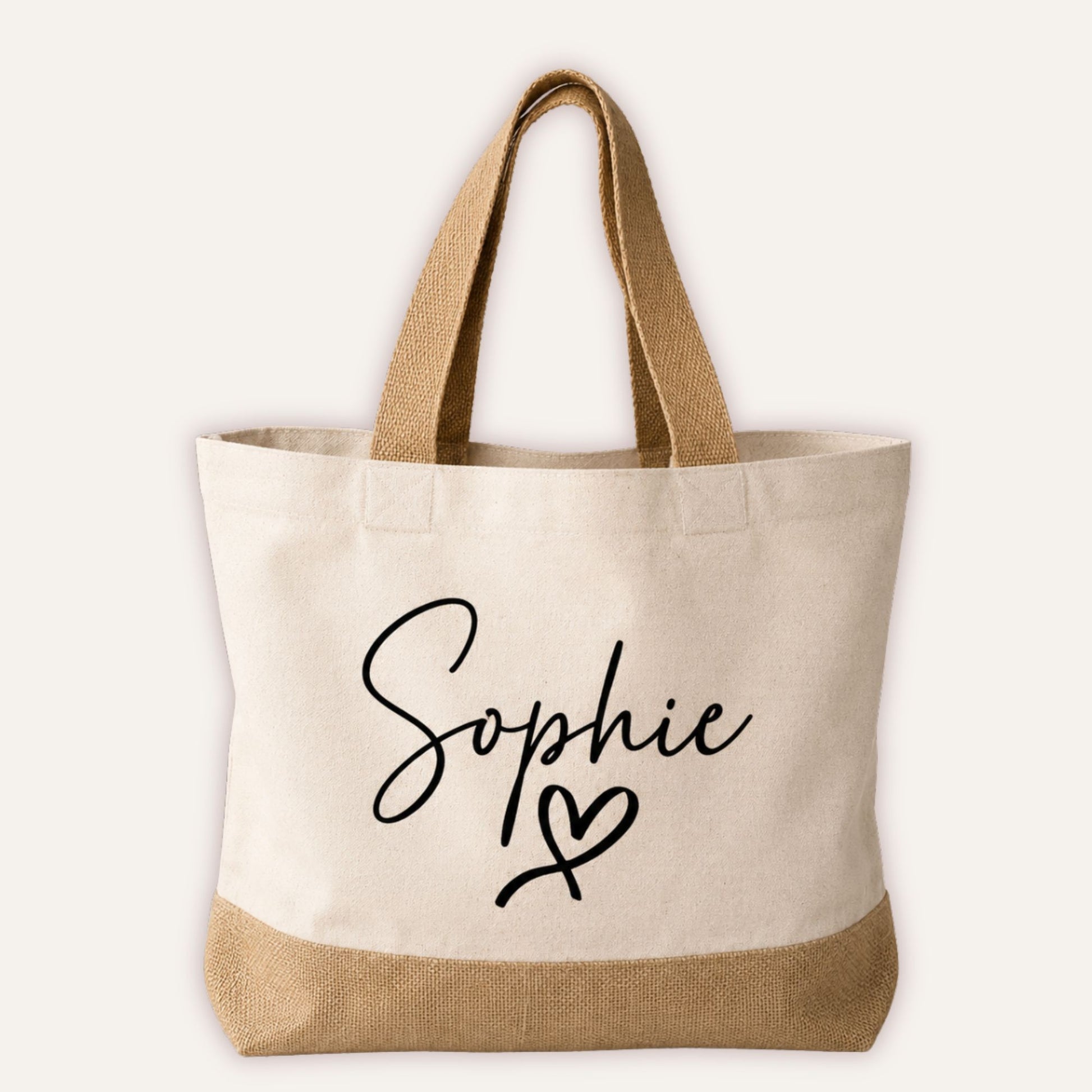 Personalised heart jute tote bag with custom name in script font and heart motif, cream canvas with natural jute base and handles | Grace & Grayson