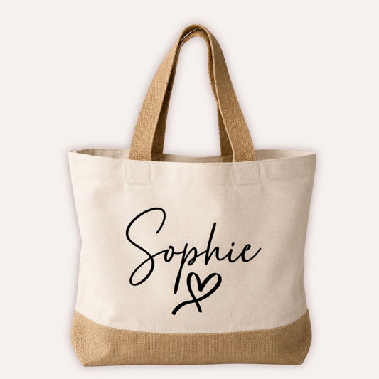 Personalised heart jute tote bag with custom name in script font and heart motif, cream canvas with natural jute base and handles | Grace & Grayson