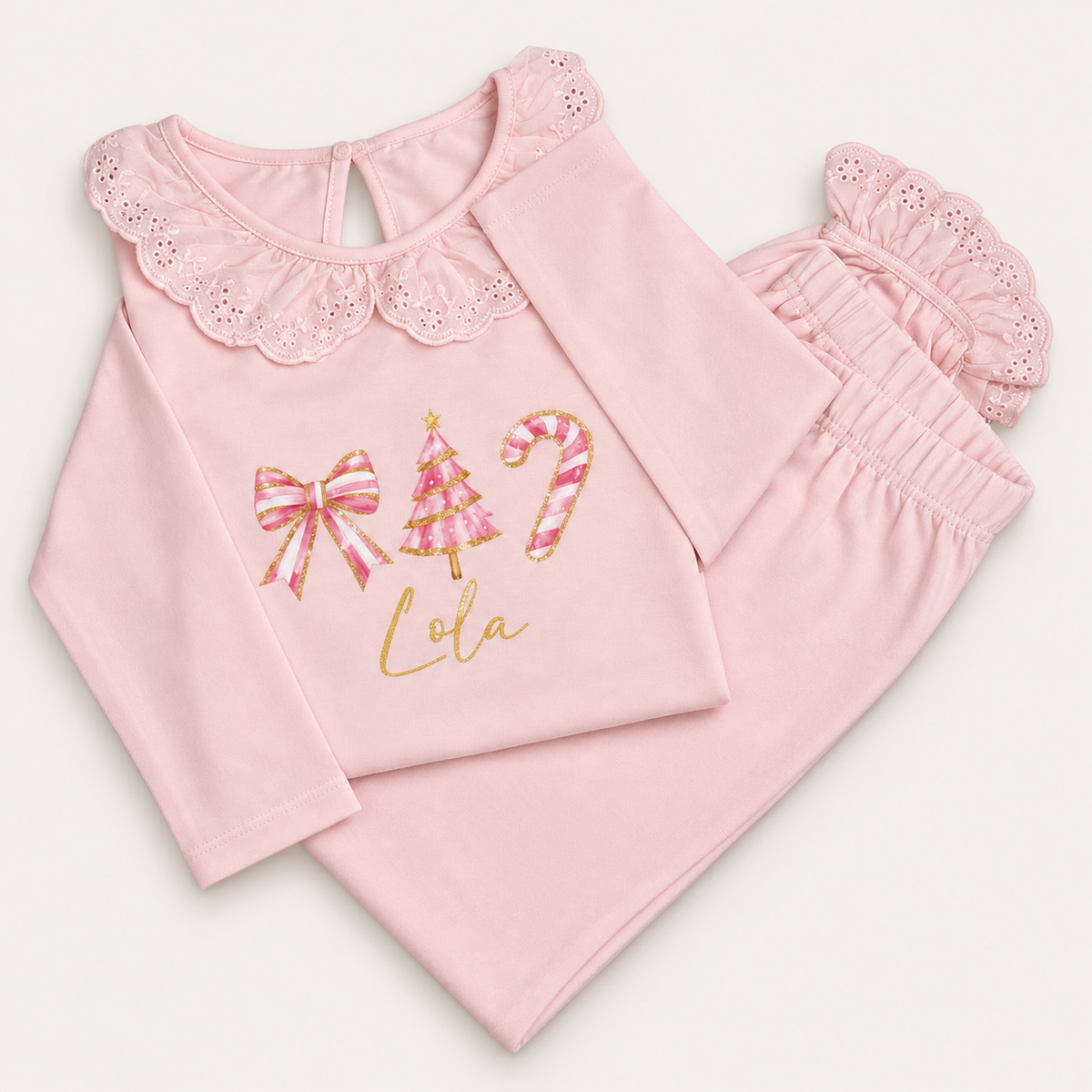 Personalised pink Christmas frill pyjamas with bow, Christmas tree and candy cane design by Grace & Grayson