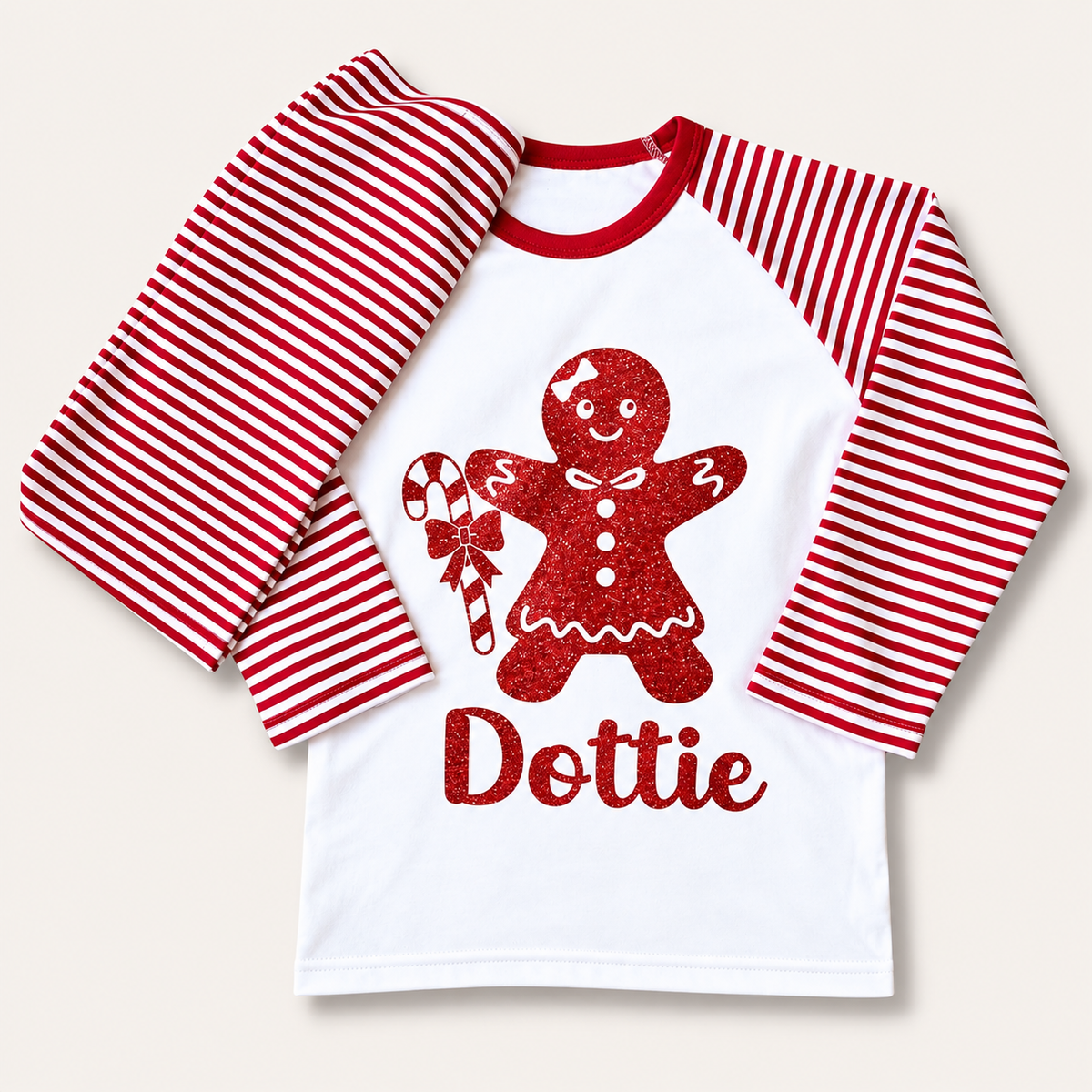 Personalised red and white striped Christmas pyjama top and bottoms with gingerbread man and candy cane design by Grace & Grayson