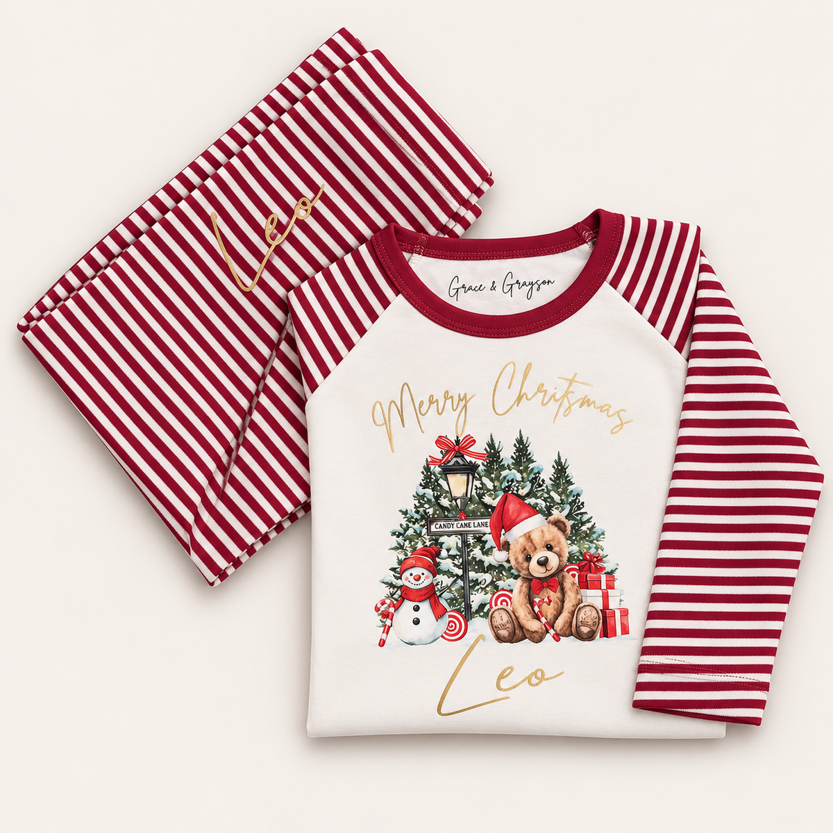 Personalised red stripe Christmas pyjamas with Candy Cane Lane bear design by Grace & Grayson