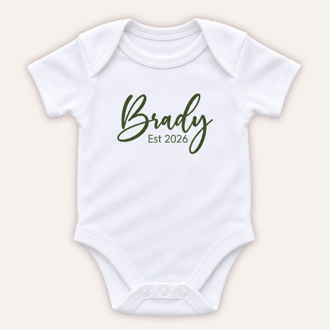 Personalised EST baby vest in olive green featuring a baby’s name and year of birth, Grace & Grayson
