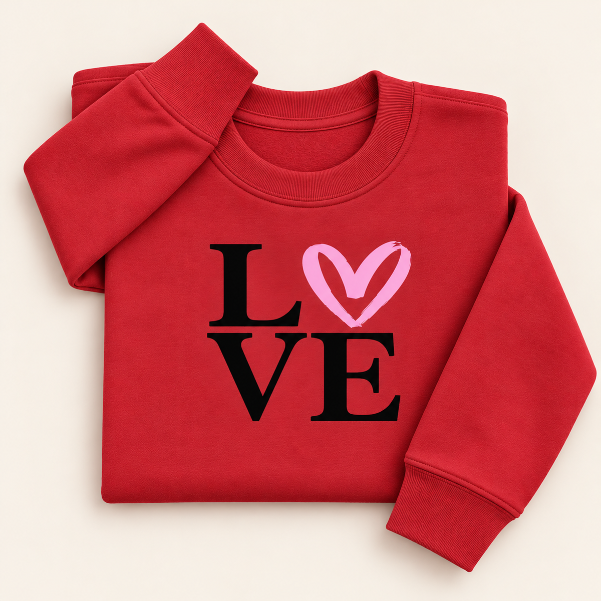 Red sweatshirt with black LOVE lettering and a pink heart replacing the O, folded on a cream background | Grace & Grayson