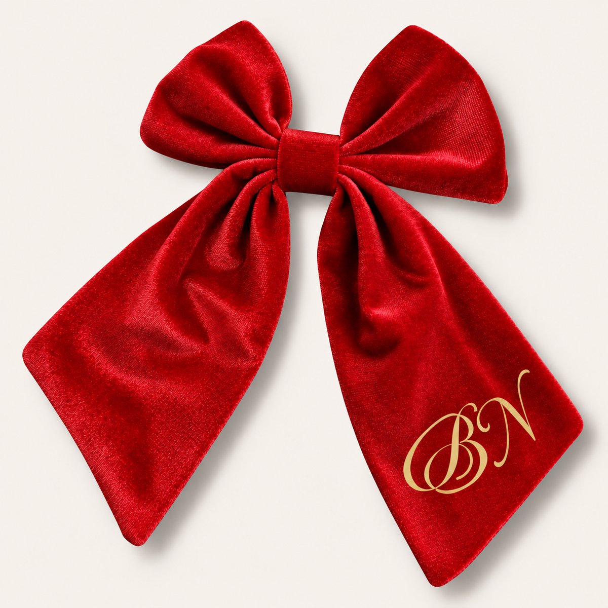 Red personalised velvet hair bow with gold fancy initials, displayed flat, Grace & Grayson