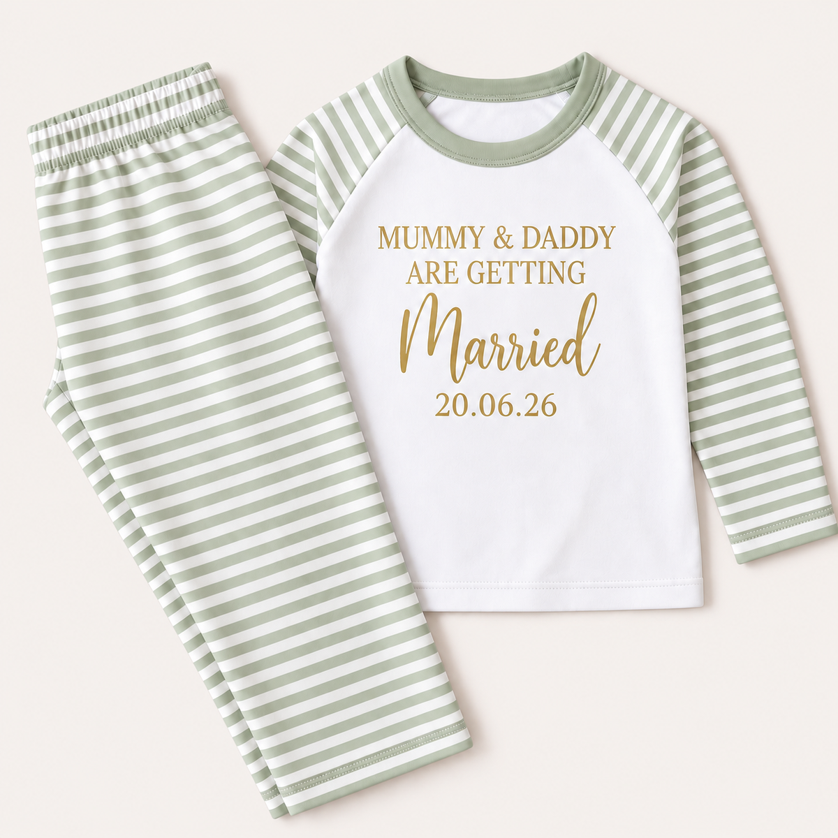 Sage green and white striped personalised children’s pyjamas laid flat with a “Mummy & Daddy Are Getting Married” design and date detail, Grace & Grayson