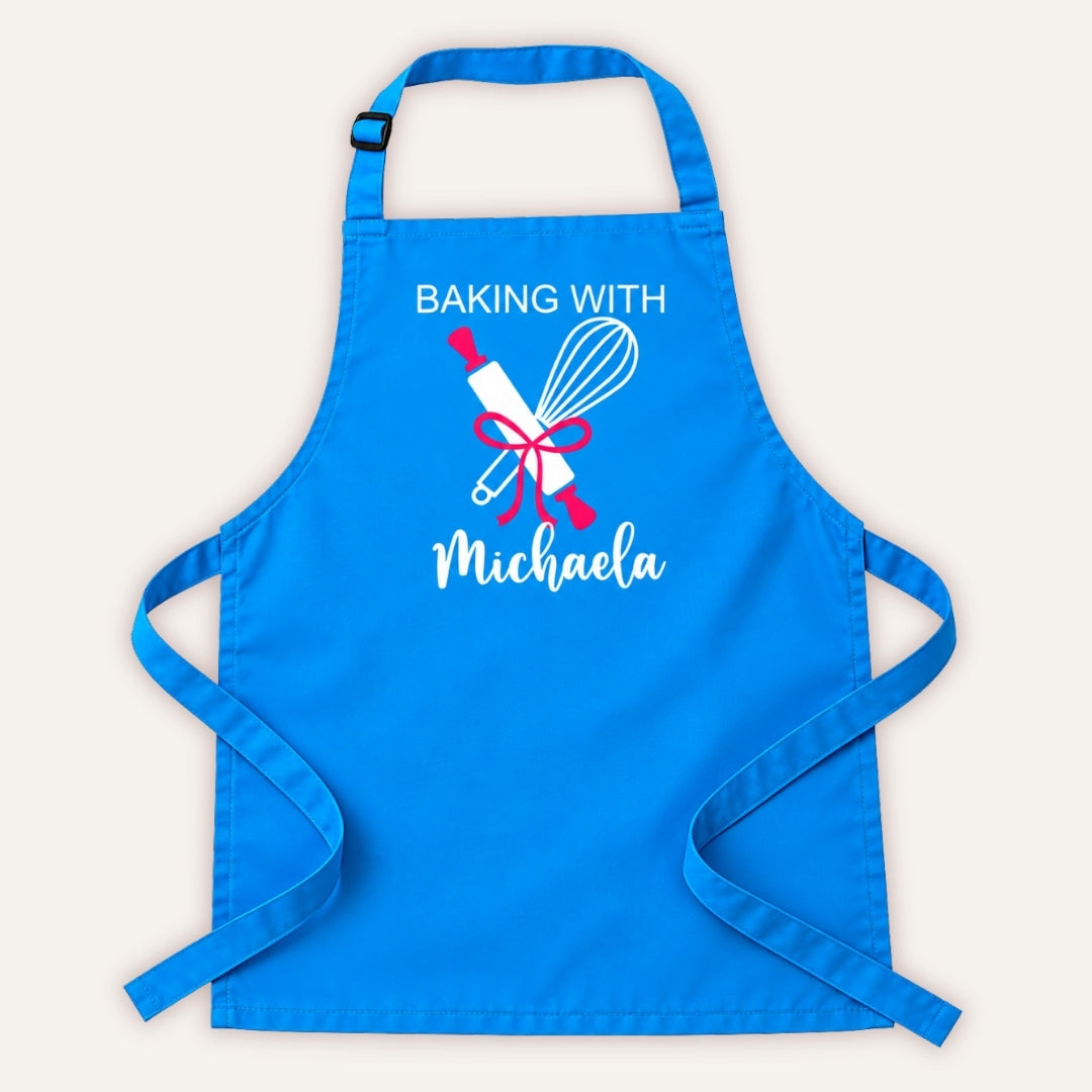 Sky blue personalised adult baking apron with “Baking With” text, rolling pin and whisk design on a white background, Grace & Grayson