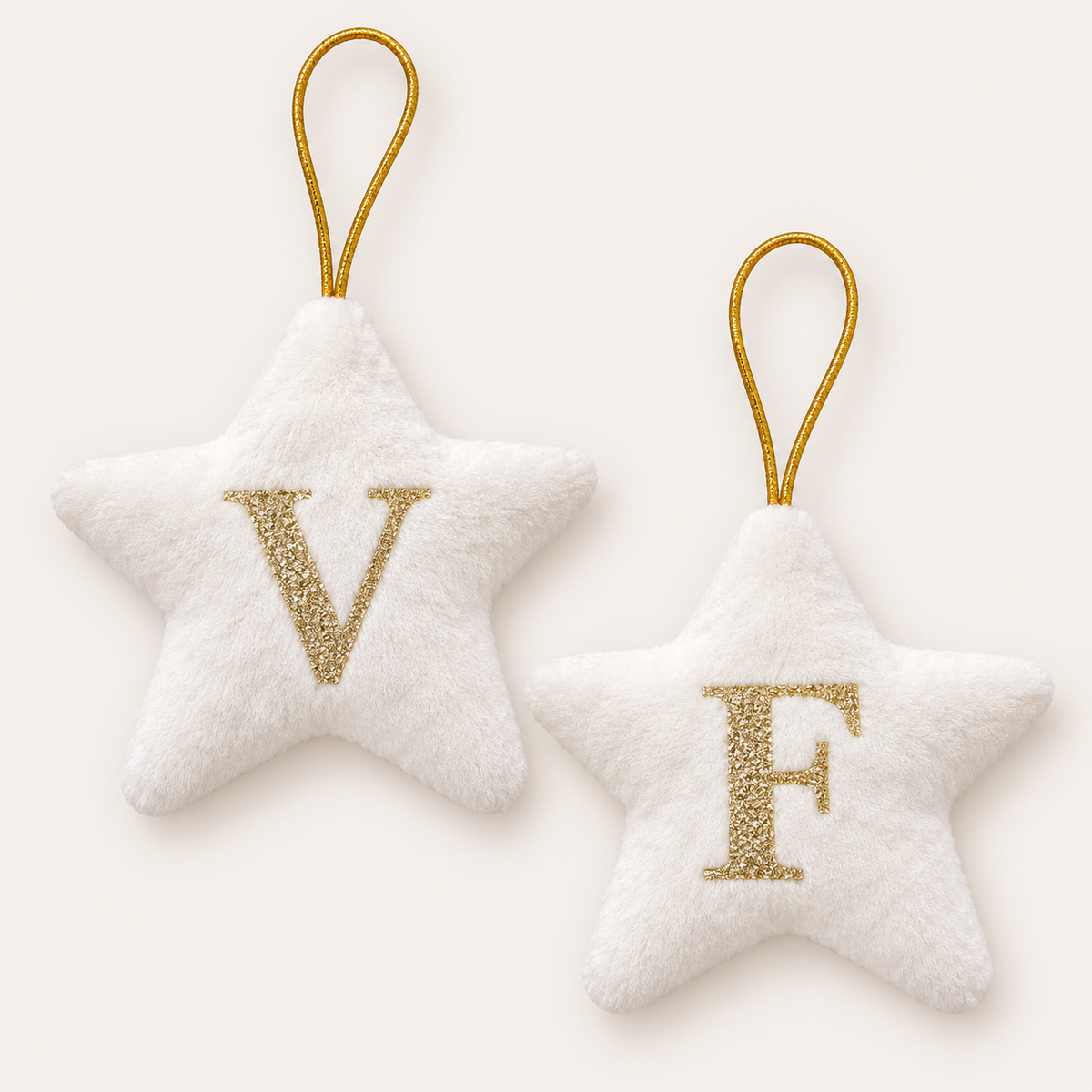 Two white personalised initial Christmas star tree decorations with gold glitter lettering, displayed together, Grace & Grayson