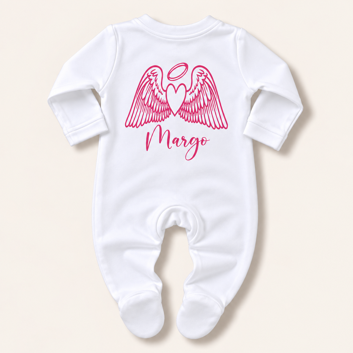 White footed baby grow with pink angel wings, halo and personalised name print, laid flat on a pale background, Grace & Grayson