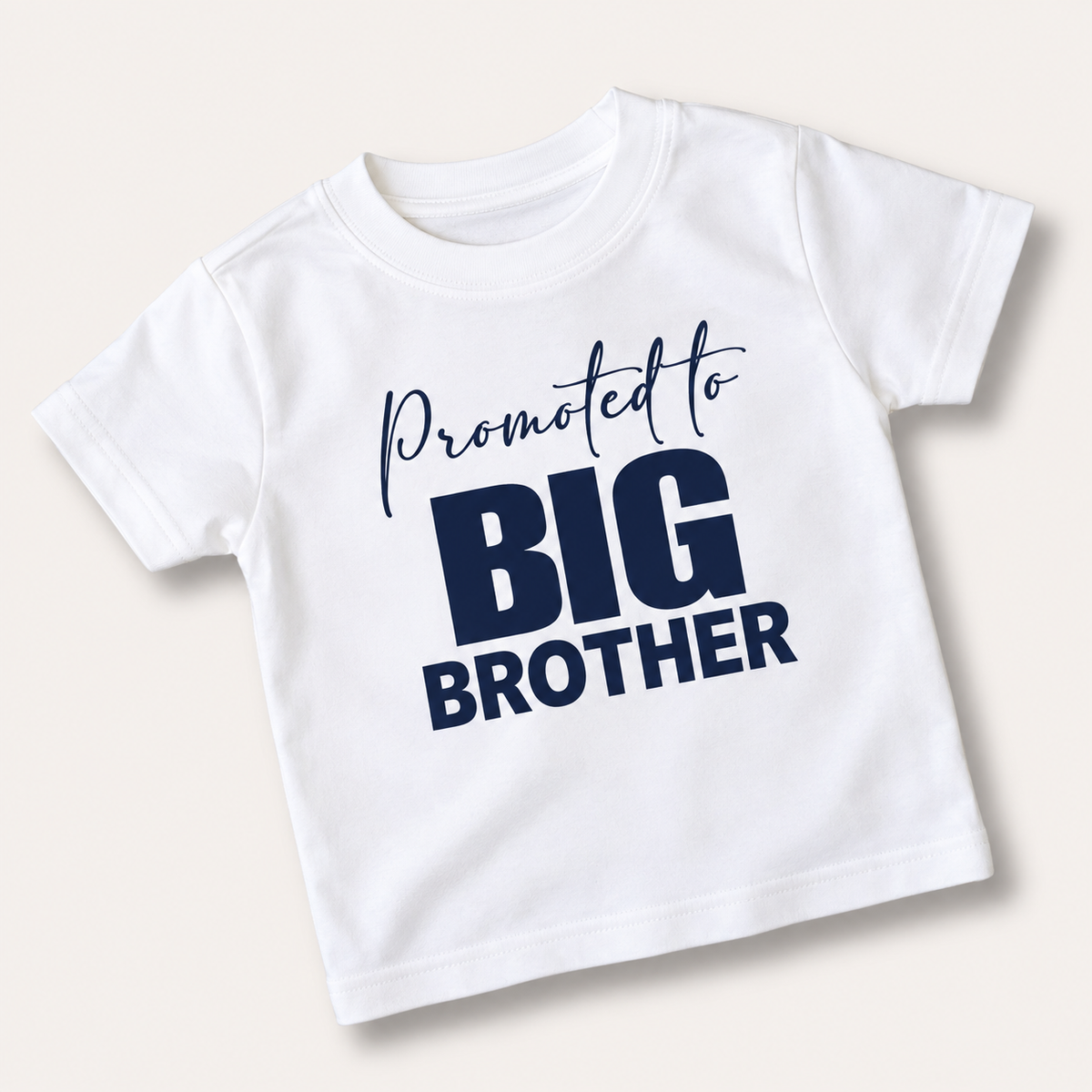 White children's “Promoted to Big Brother” t-shirt with navy lettering, Grace & Grayson.