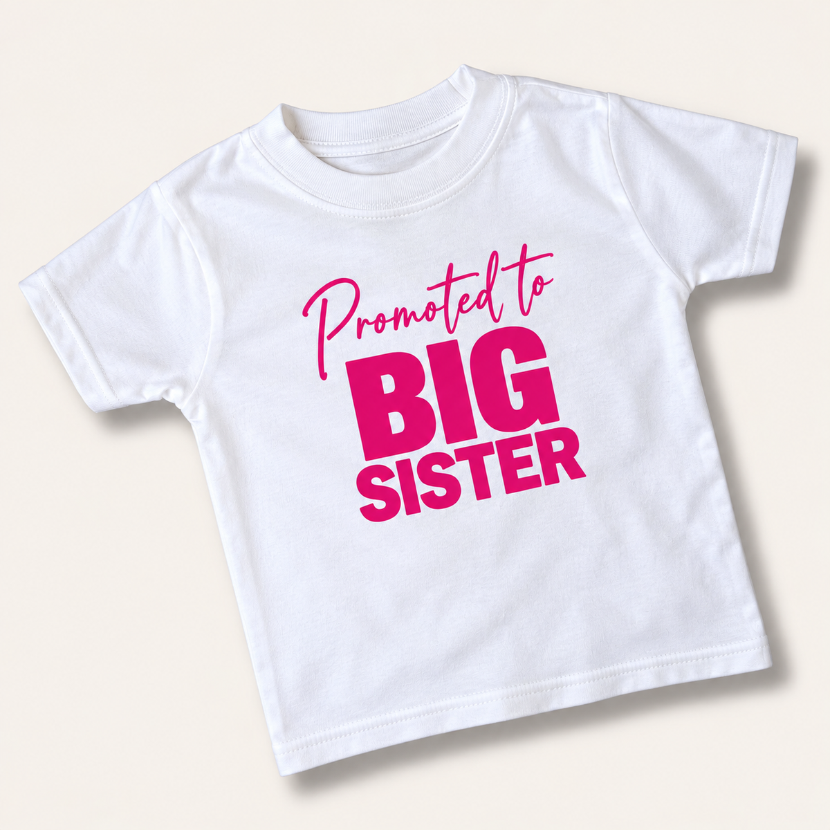 White children's “Promoted to Big Sister” t-shirt with pink lettering, Grace & Grayson.
