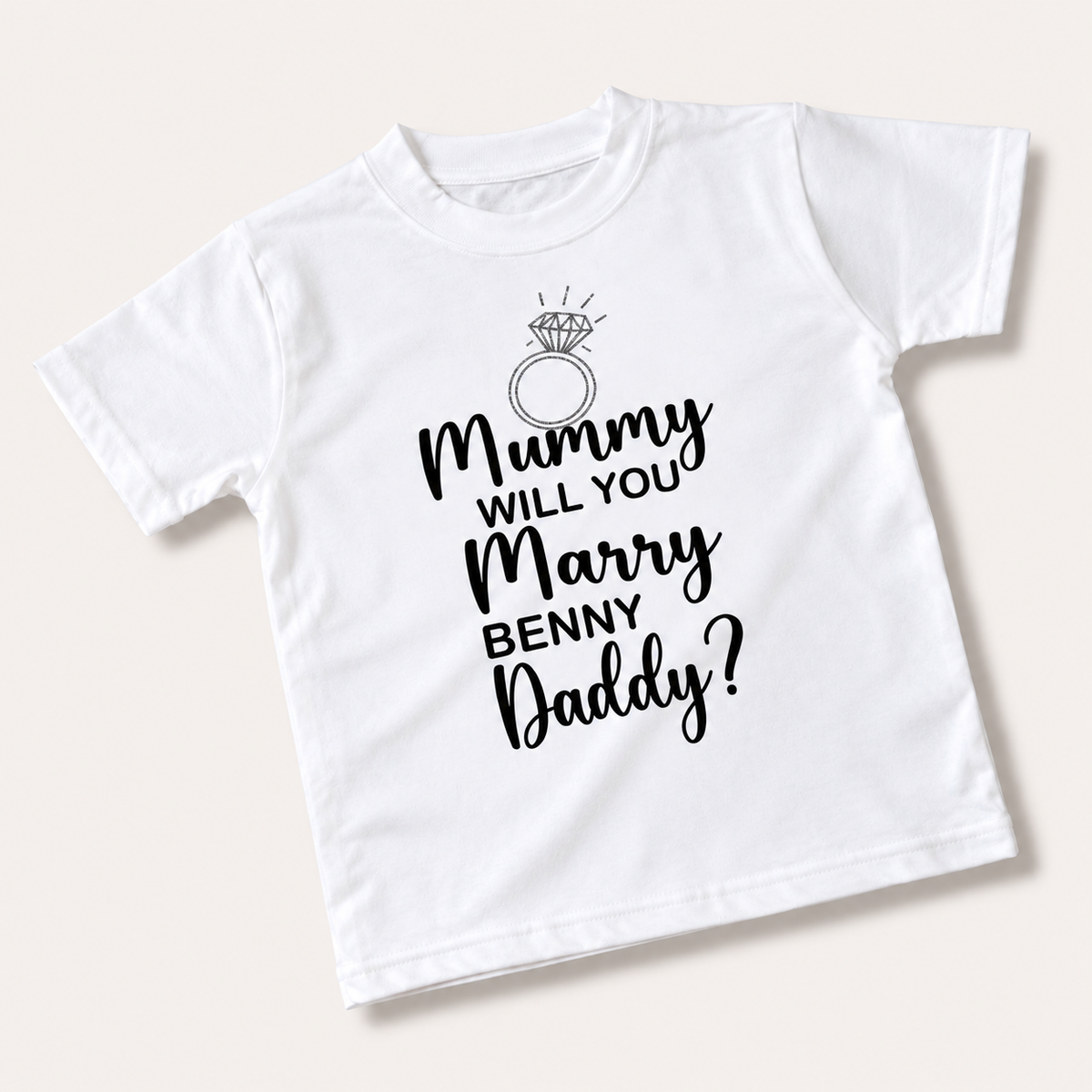 White children’s personalised proposal T-shirt laid flat with a ring illustration and “Mummy Will You Marry My Daddy?” text, Grace & Grayson