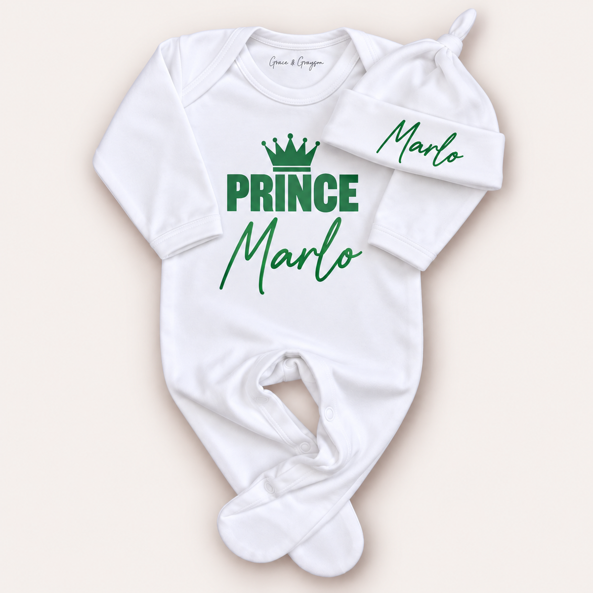 White personalised Prince baby grow and matching hat with green crown lettering, Grace & Grayson