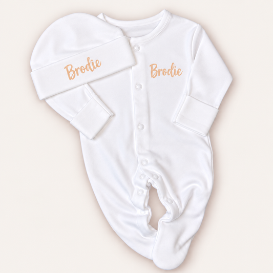 White personalised baby grow and matching hat with neutral lettering, shown on a light background, Grace & Grayson