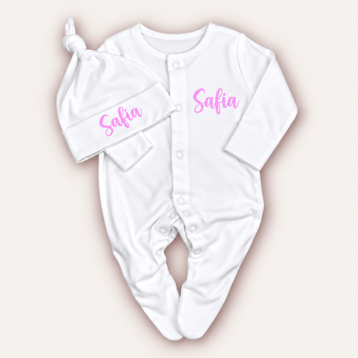 White personalised baby grow and matching knotted hat with pink lettering, Grace & Grayson